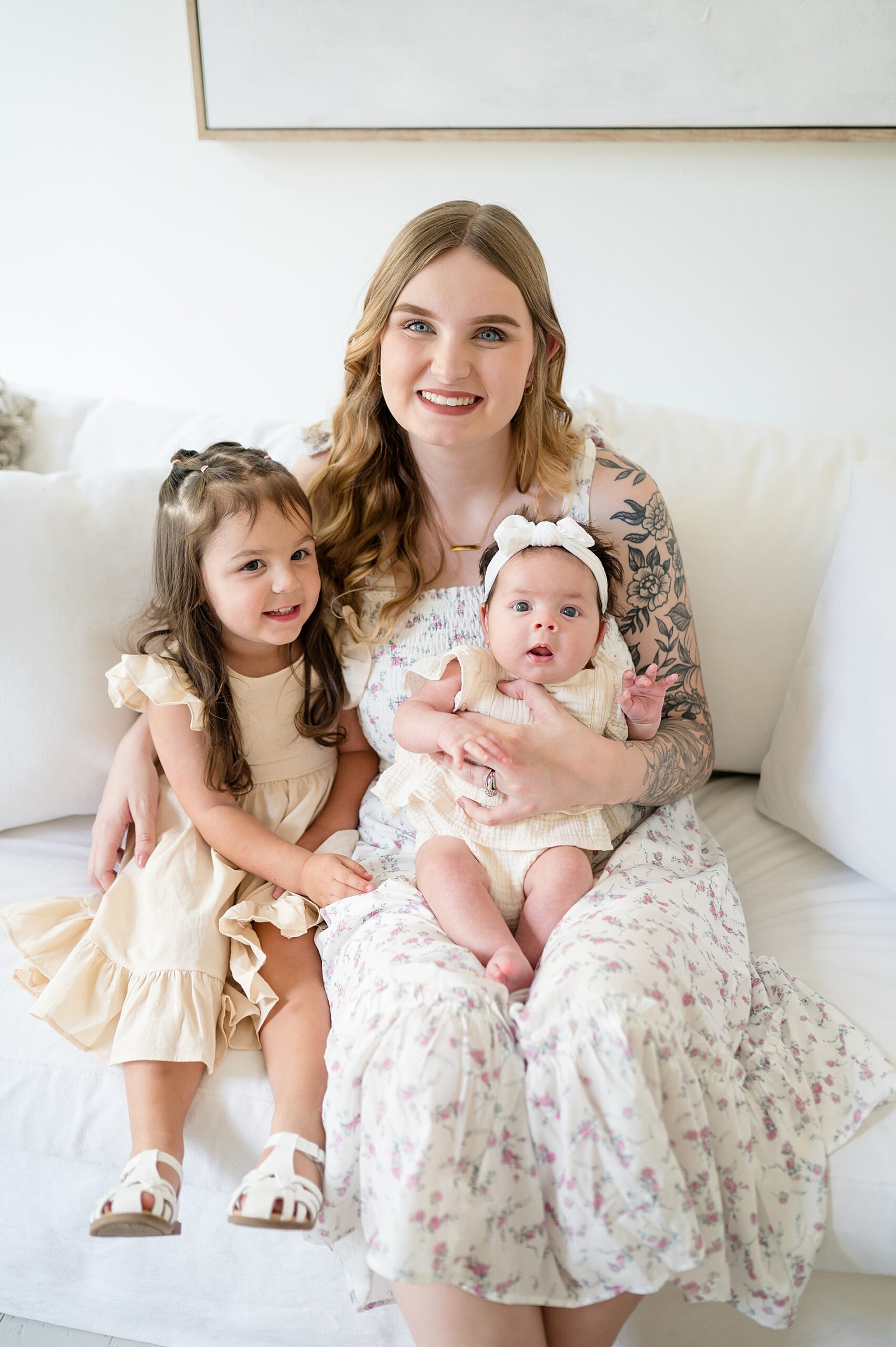 mom sits with her two daughters by Family Photographer in McKinney, TX