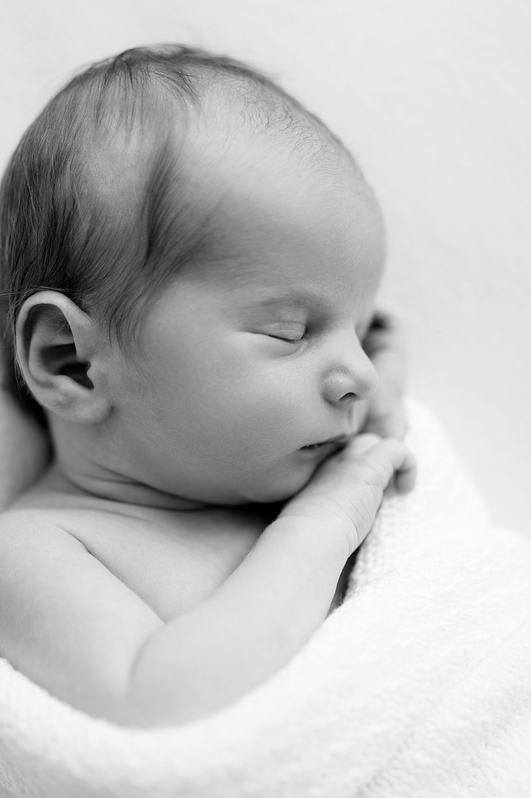 newborn sleeps soundly cuddled in blanket | Frisco, Tx Newborn photography