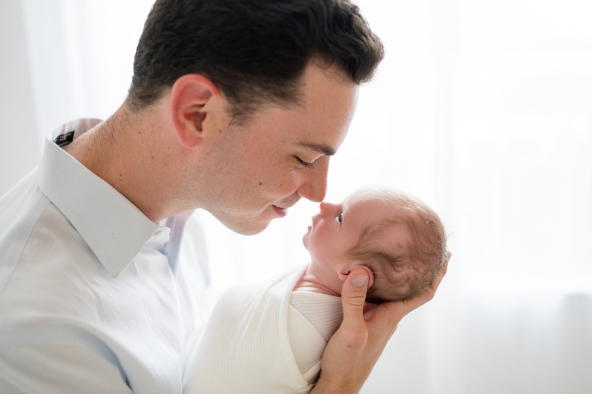 dad leans in to newborn | Frisco Texas newborn photography