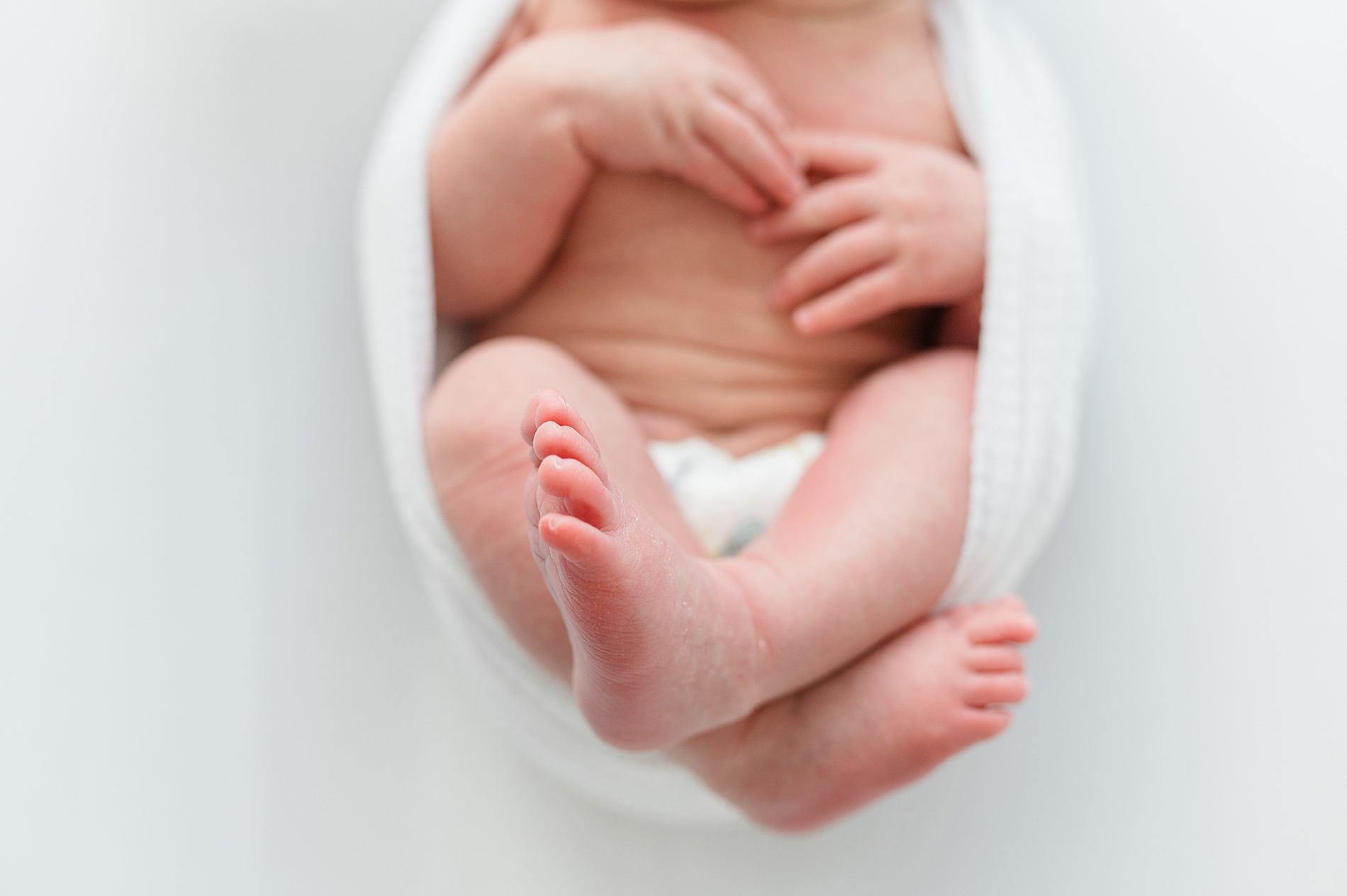 tiny newborn wrapped in blanker