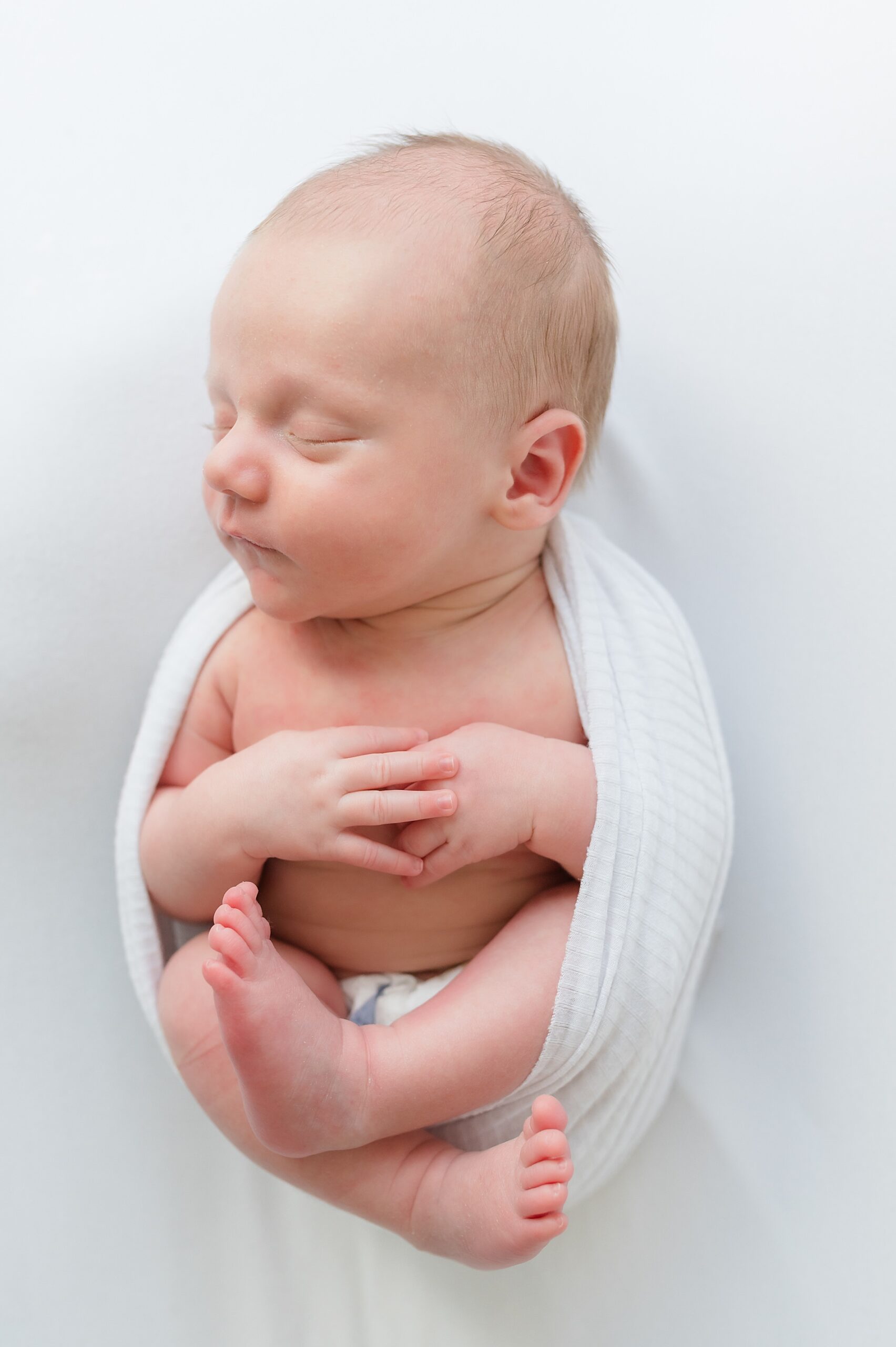newborn wrapped in white blanket