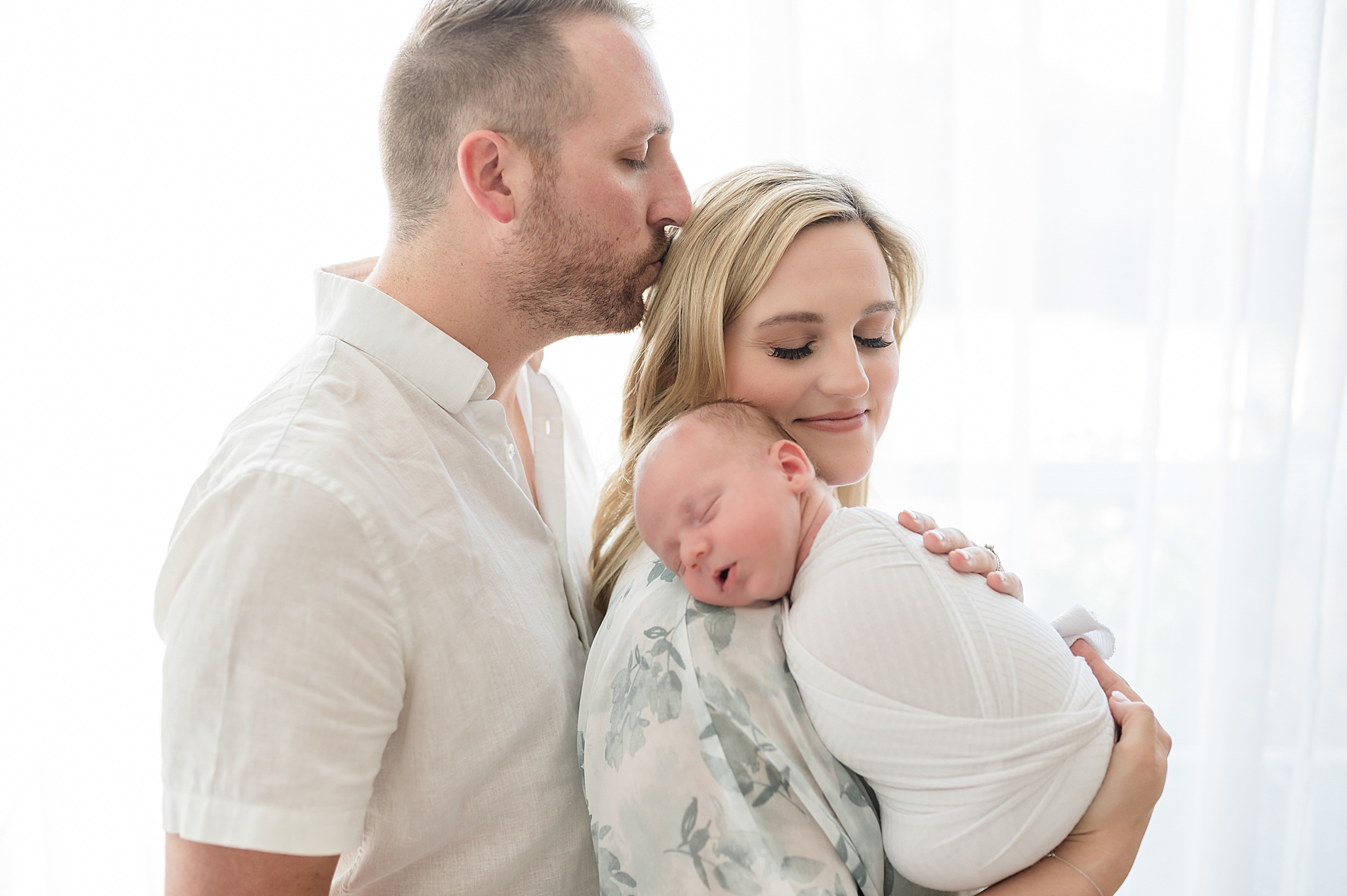parents hold newborn during newborn session as part of Dallas Milestone photographer's First year collection