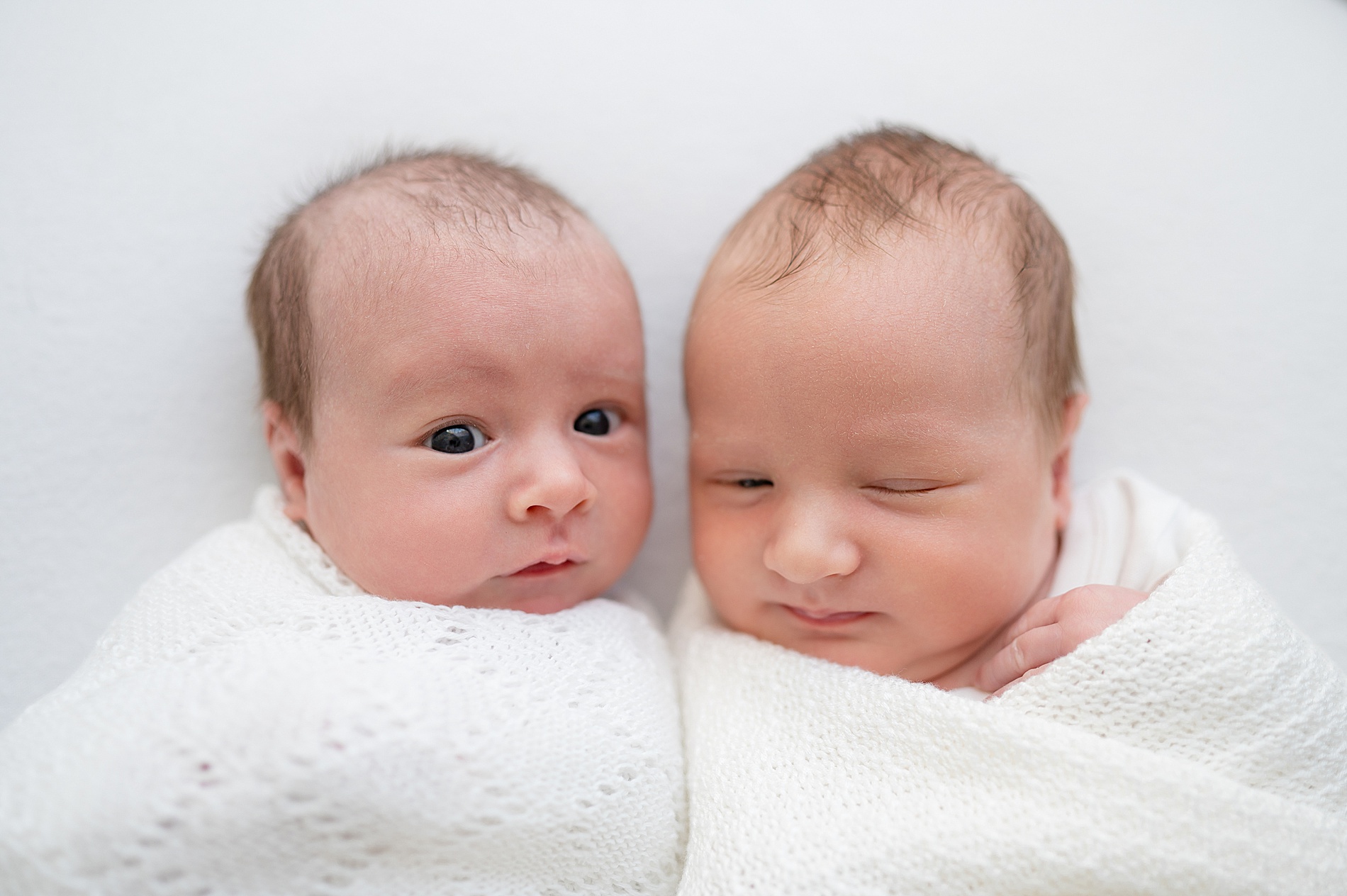 twins wrapped in white blankets during Baby-Led Twin Newborn Session in Texas Studio