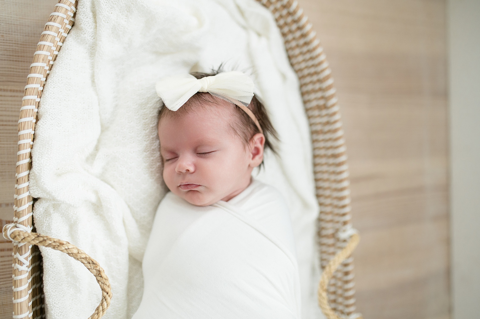 newborn girl sleeps in bassinet