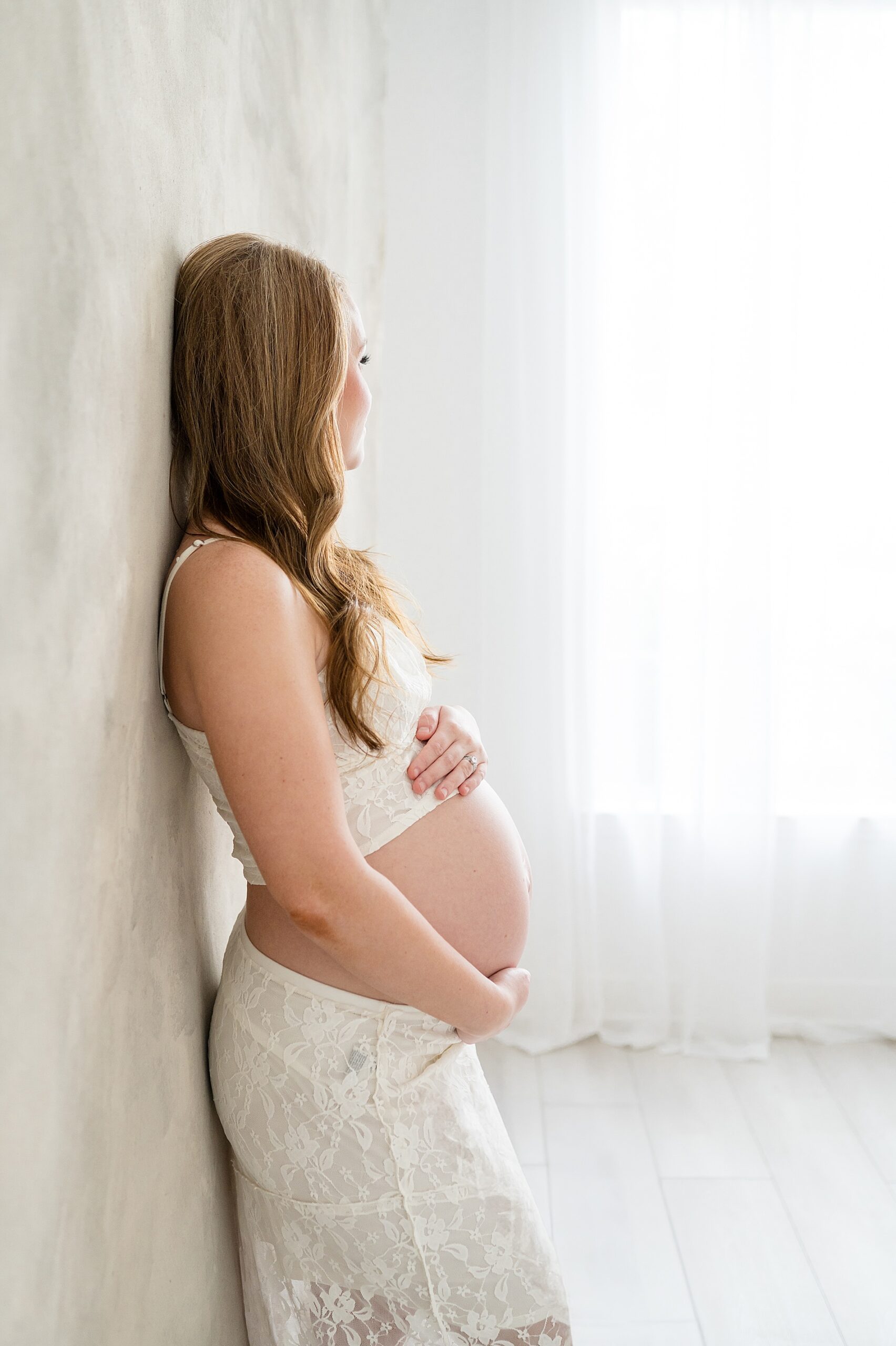 mom holds baby bump