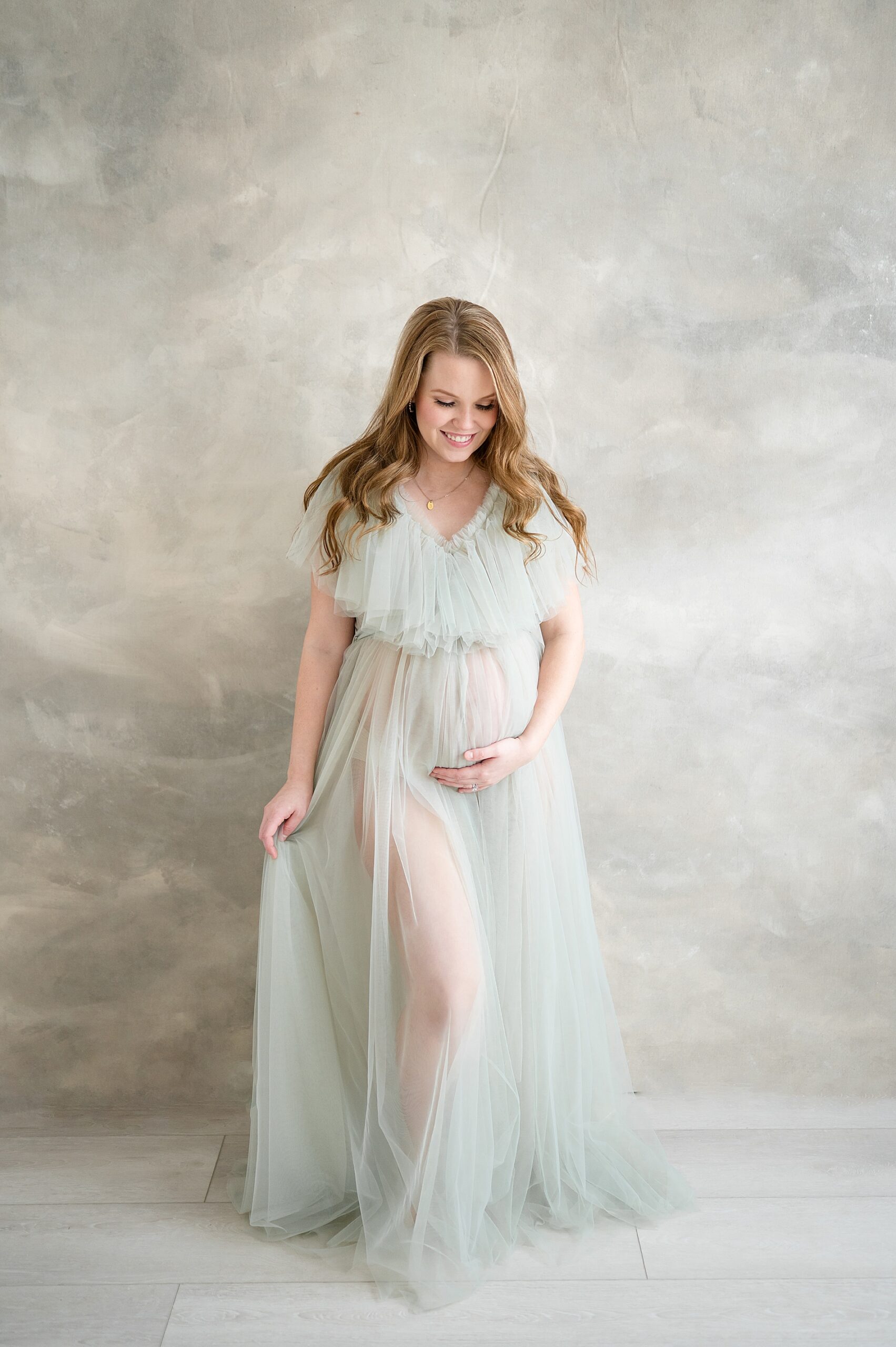 pregnant woman in tulle dress from Intimate Studio Maternity Session