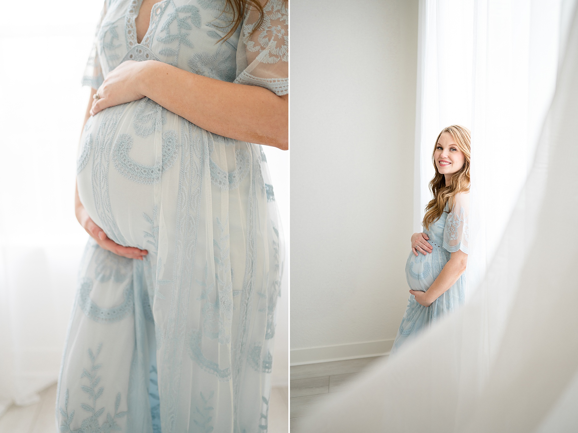 woman in light blue maternity dress stands by window 