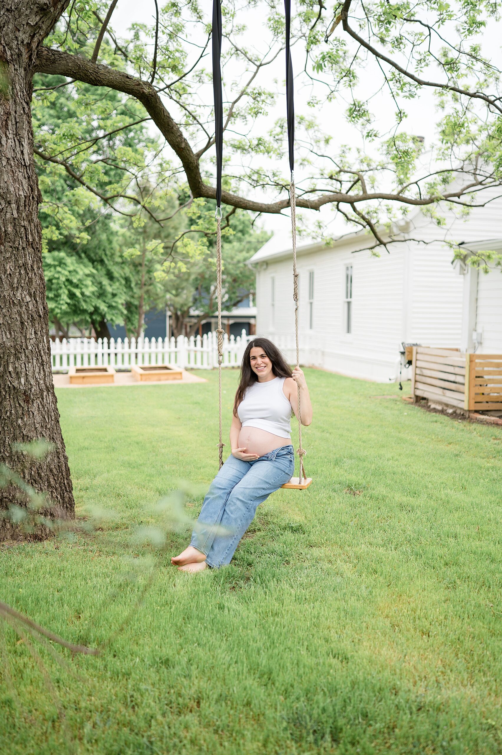 expectant mom on swing during Dallas maternity session