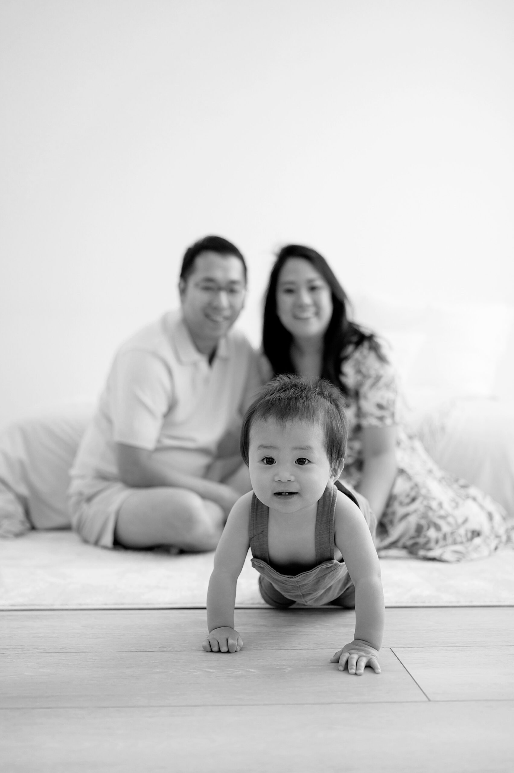 parents watch as son crawls across floor