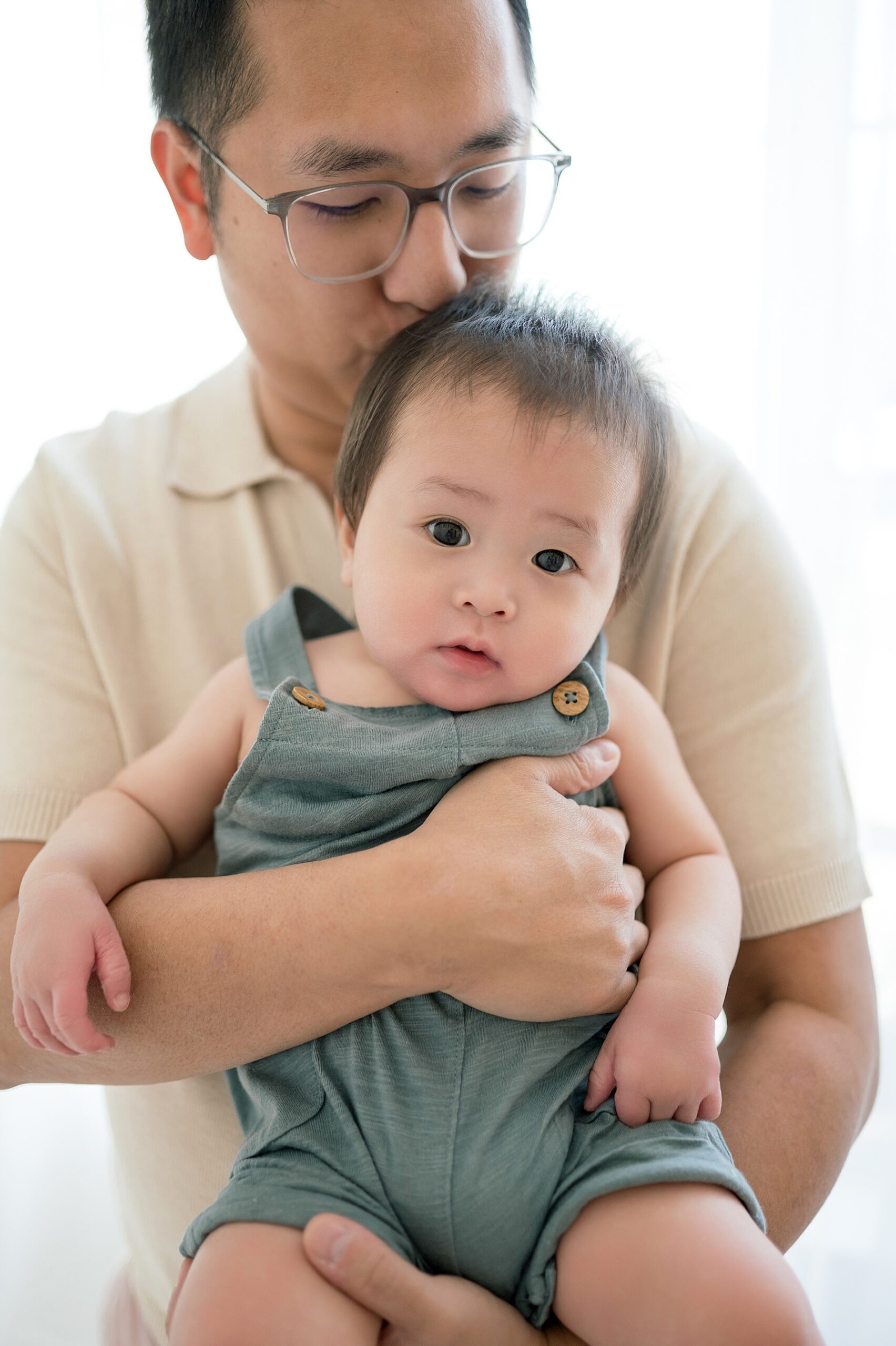 dad kisses son's head