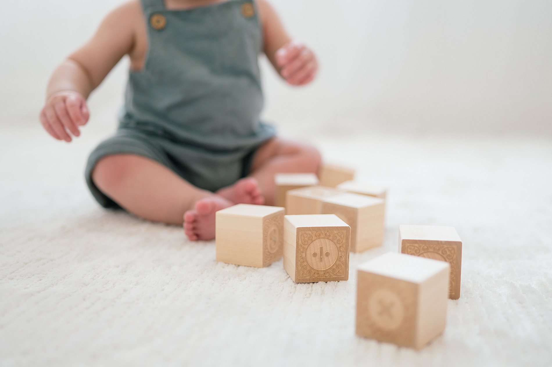 little boy plays with blocks by One Year Milestone Photographer in Dallas