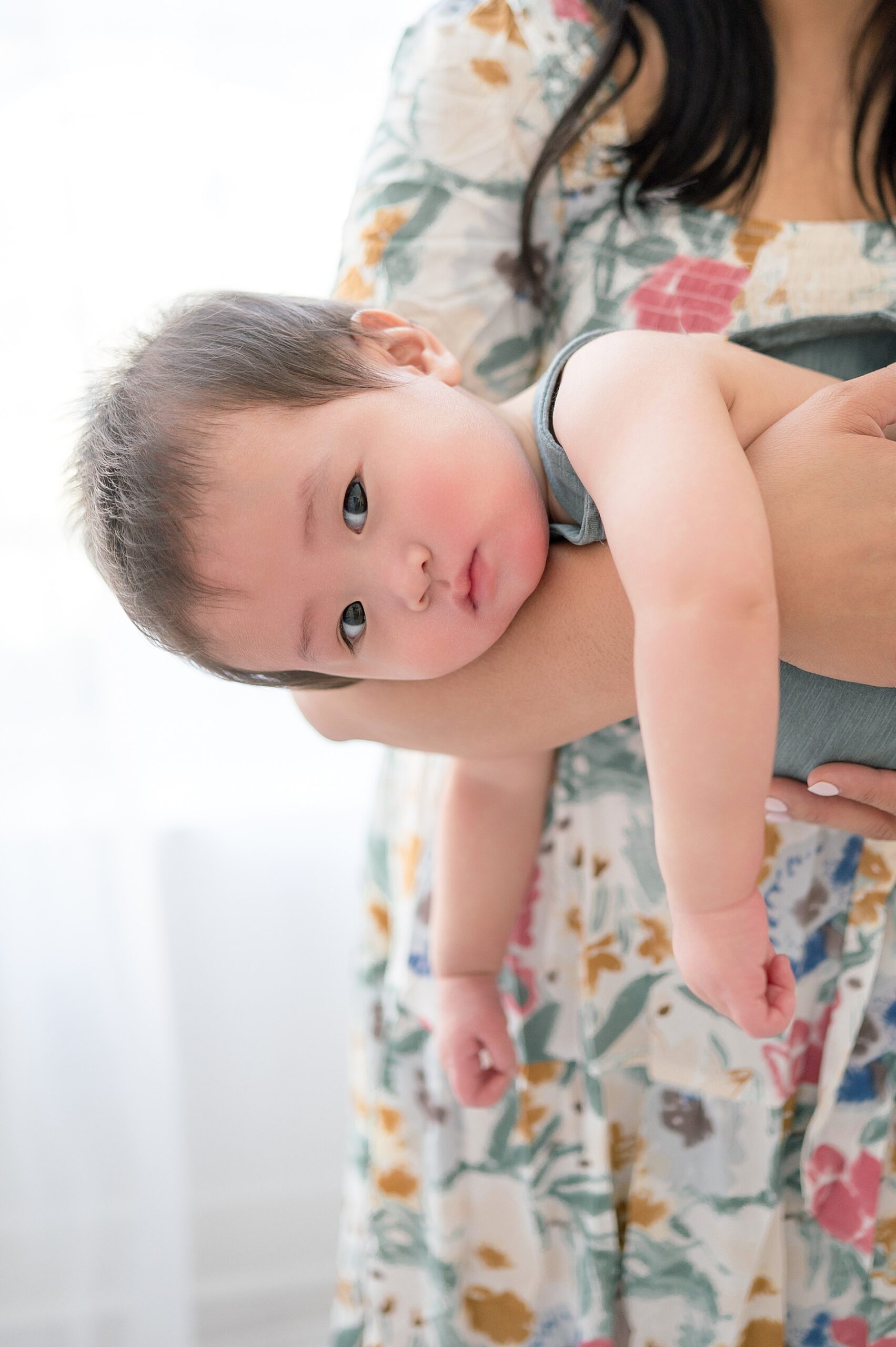 mom holds little boy in arms