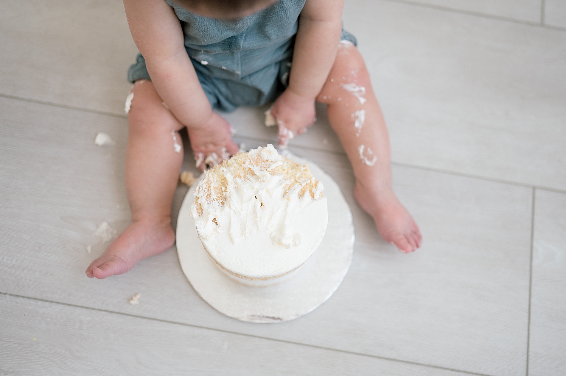 curious boy tries cake for the first time during First Birthday Cake Smash Session