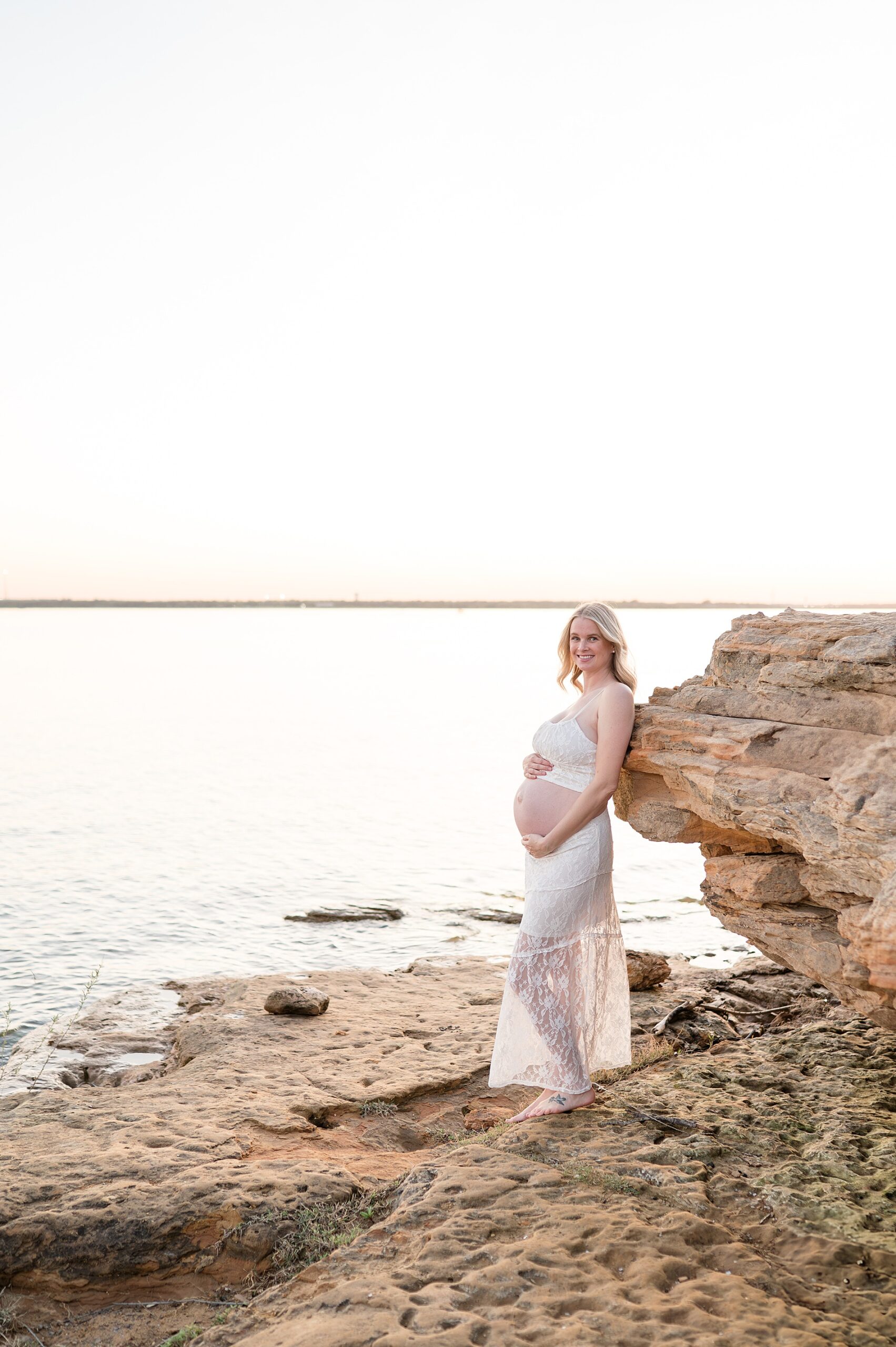 woman wears two piece skirt outfit to show off baby bump during maternity photoshoot