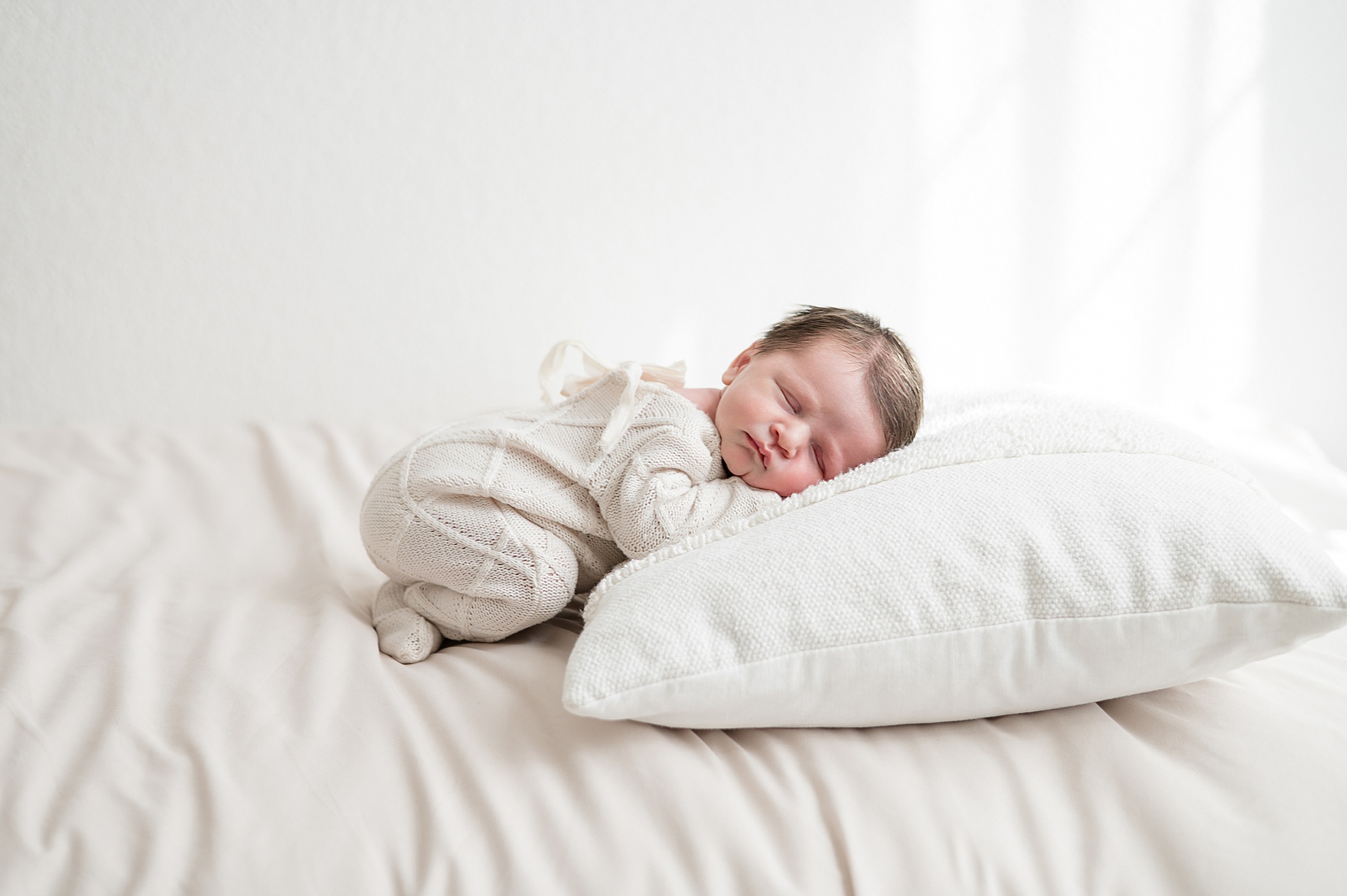 newborn on pillow