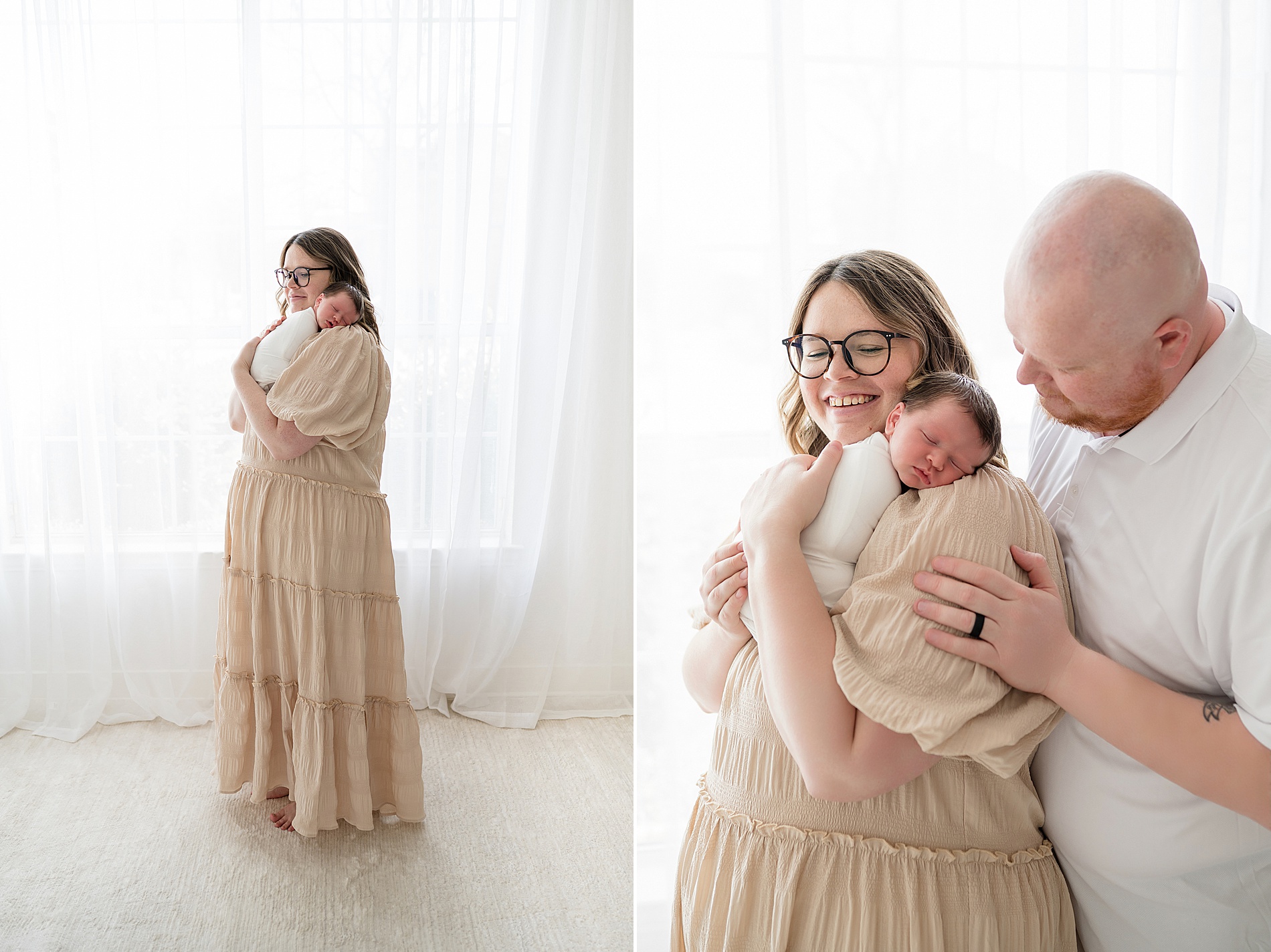 mom and dad hold newborn by window of studio in Dallas