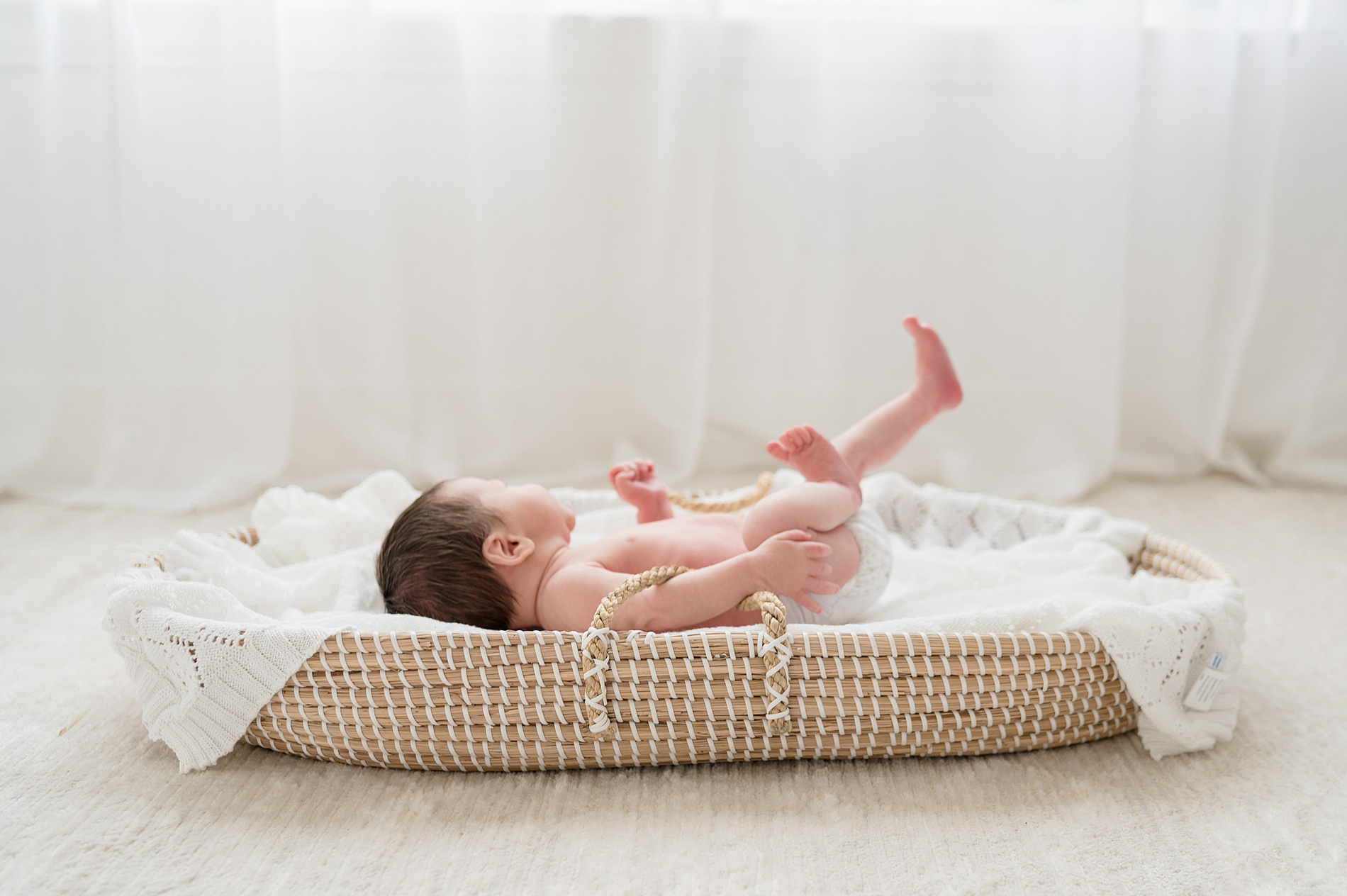newborn in bassinet