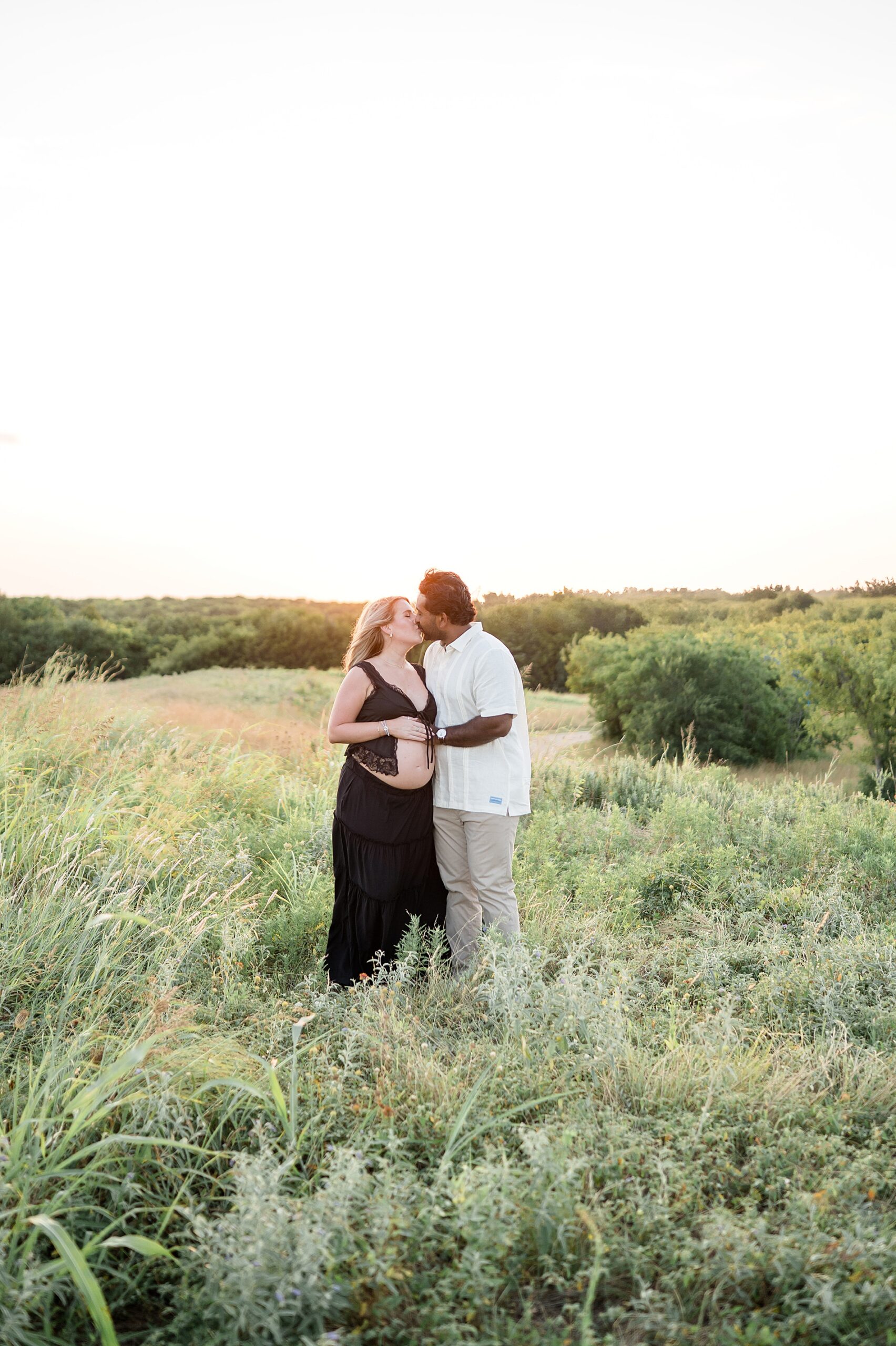expectant parents kiss during dreamy maternity session