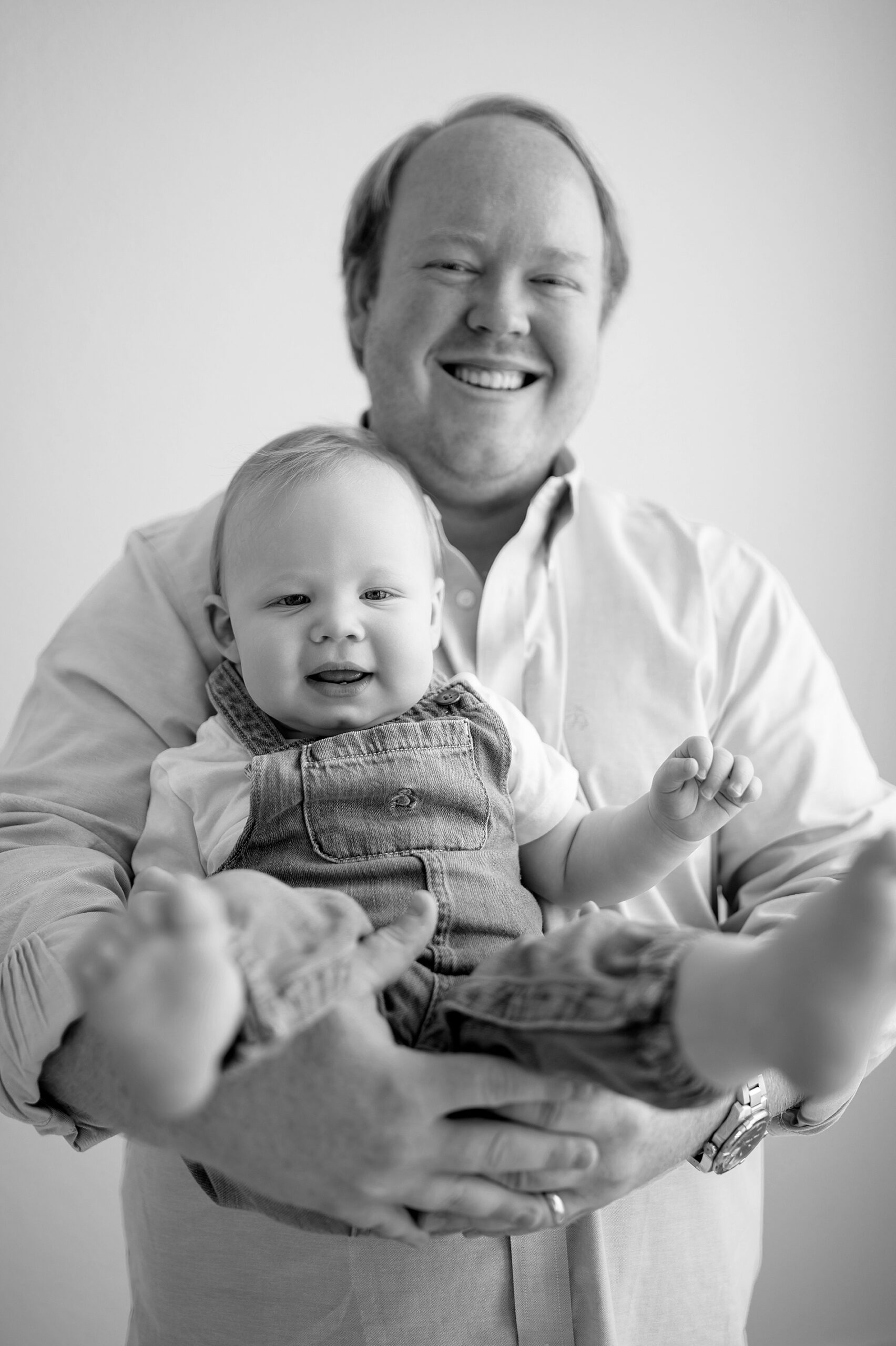 dad holds son in arms