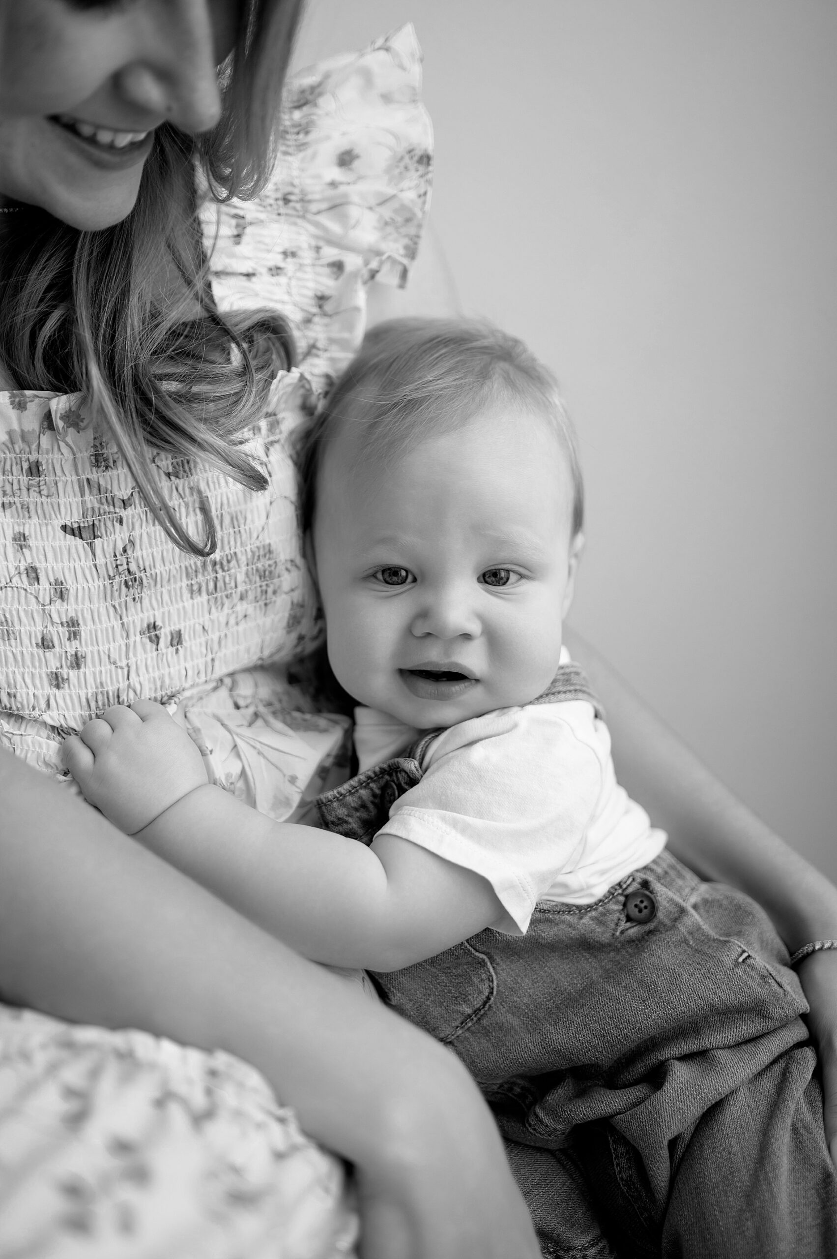 1 year old boy sits with his mom in Little Elm studio 