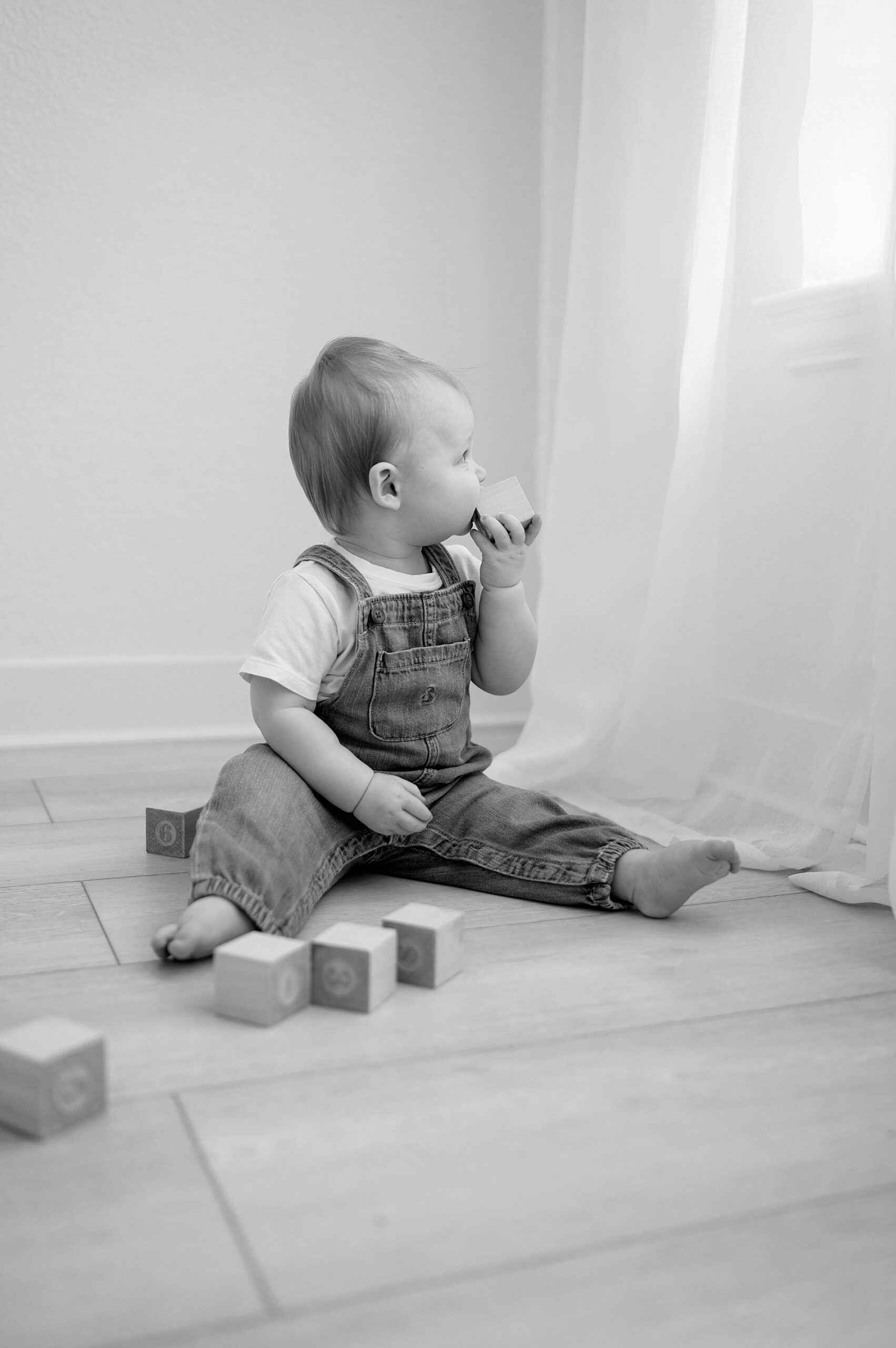 timeless photos of little boy playing with wooden blocks during milestone session 