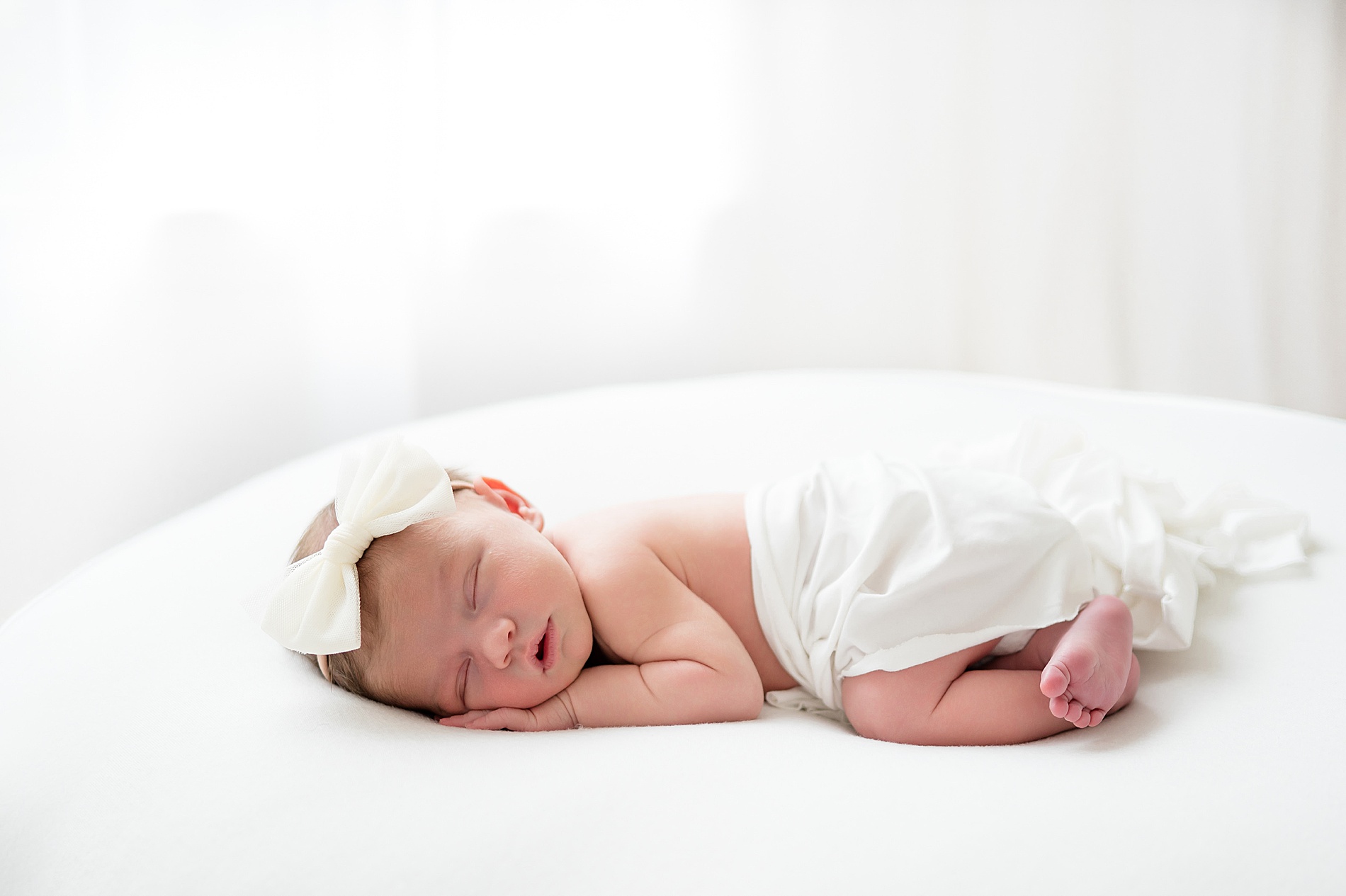 Newborn sleeps with white backdrop and natural light | light and airy Studio Newborn Photography in Little Elm, TX