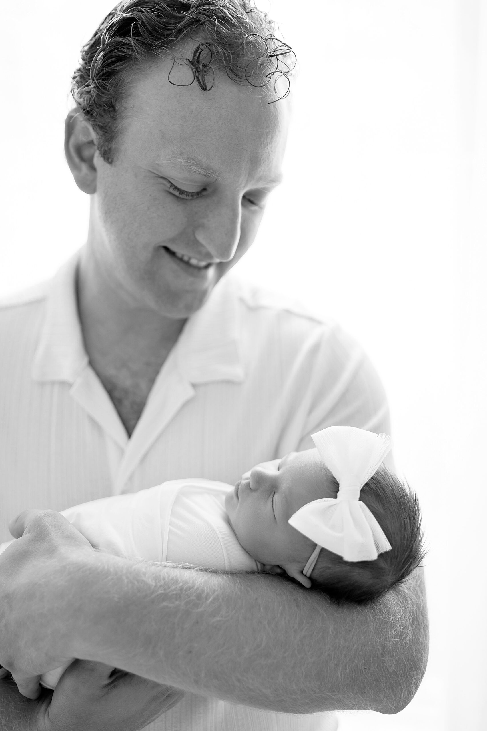 newborn photographer in little elm, TX captures dad cradling newborn