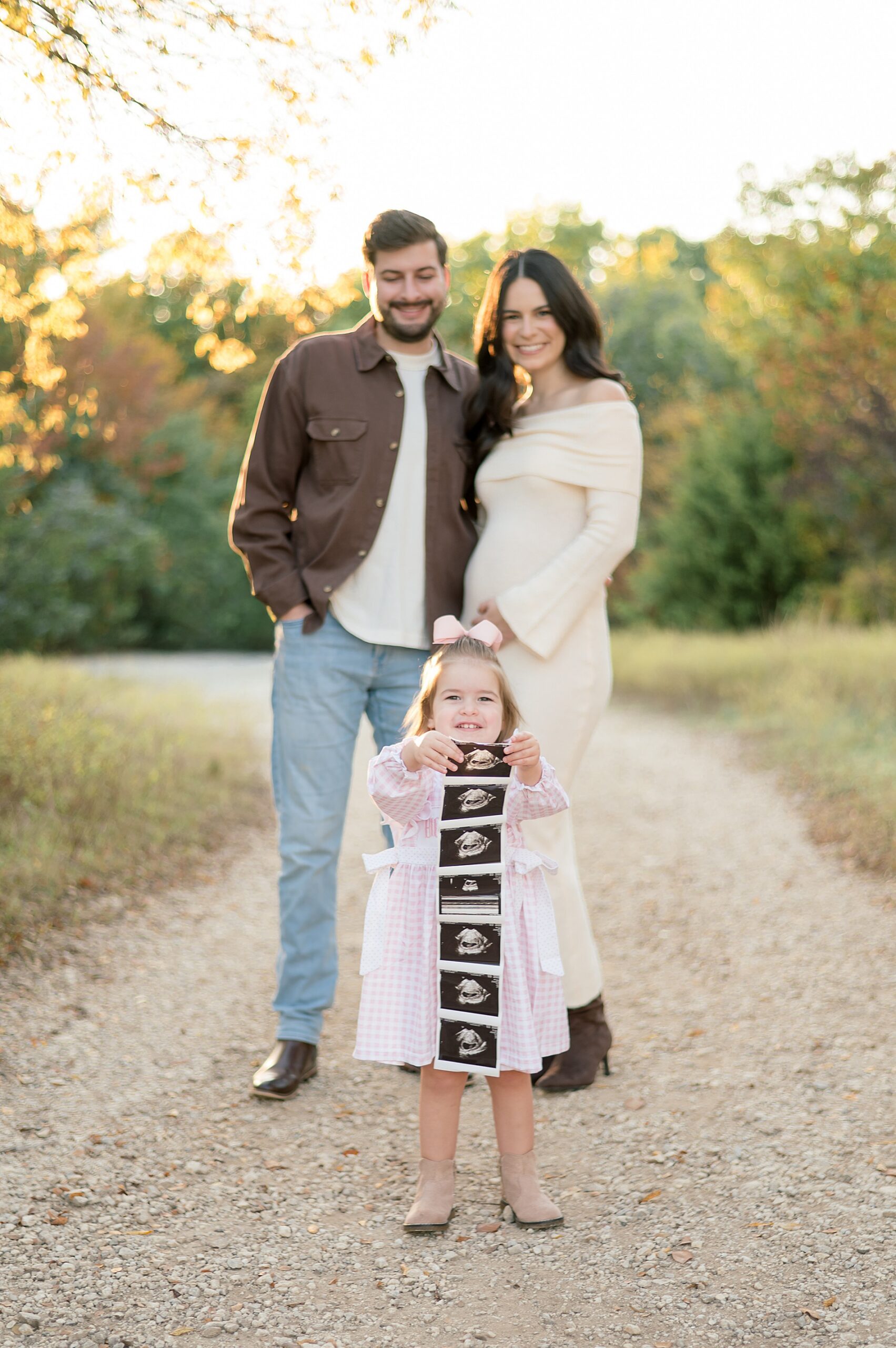 little girl holds up ultrasound photo during Arbor Hills Maternity Announcement