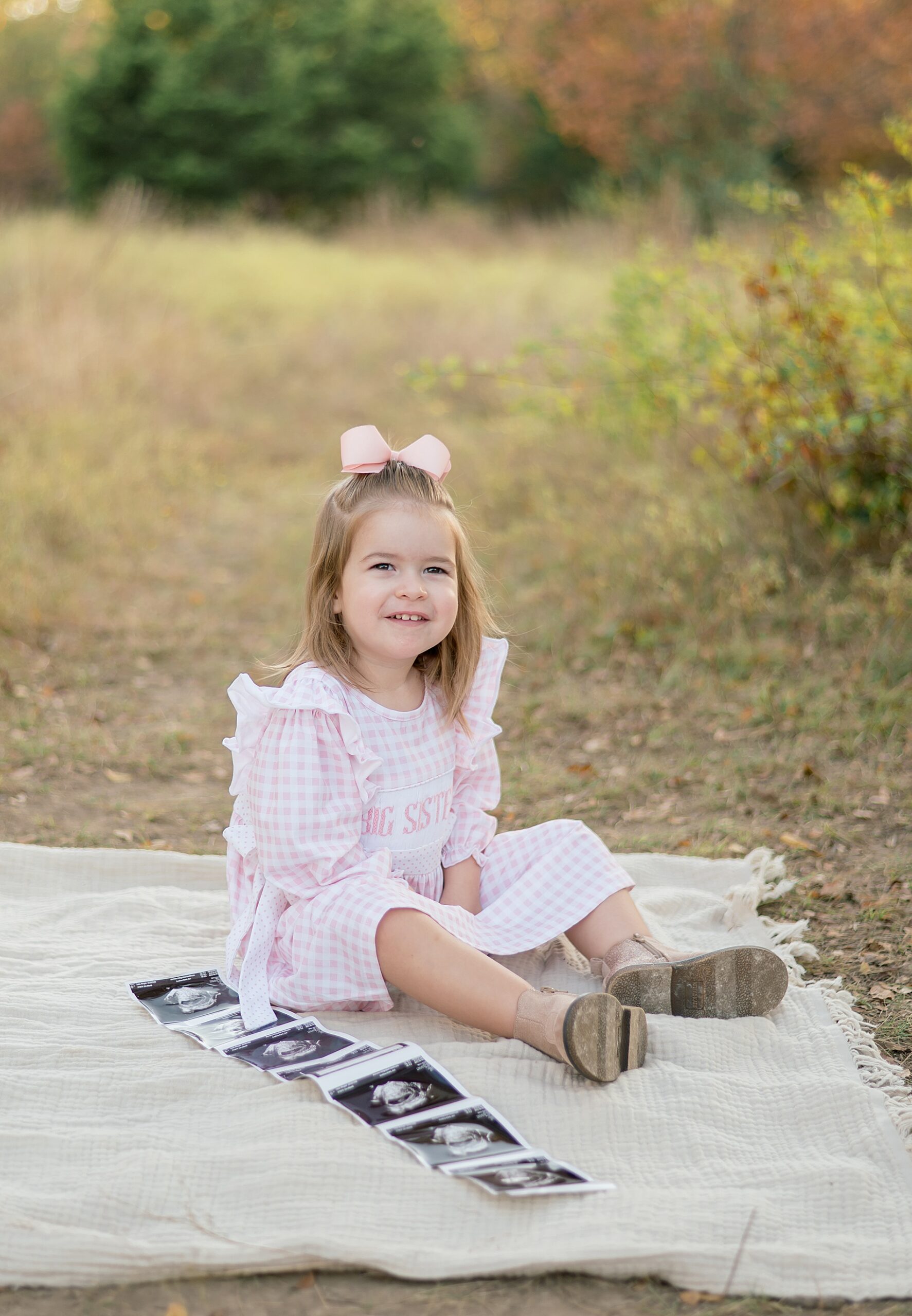 little girl looks at ultrasound photo of new sibling 