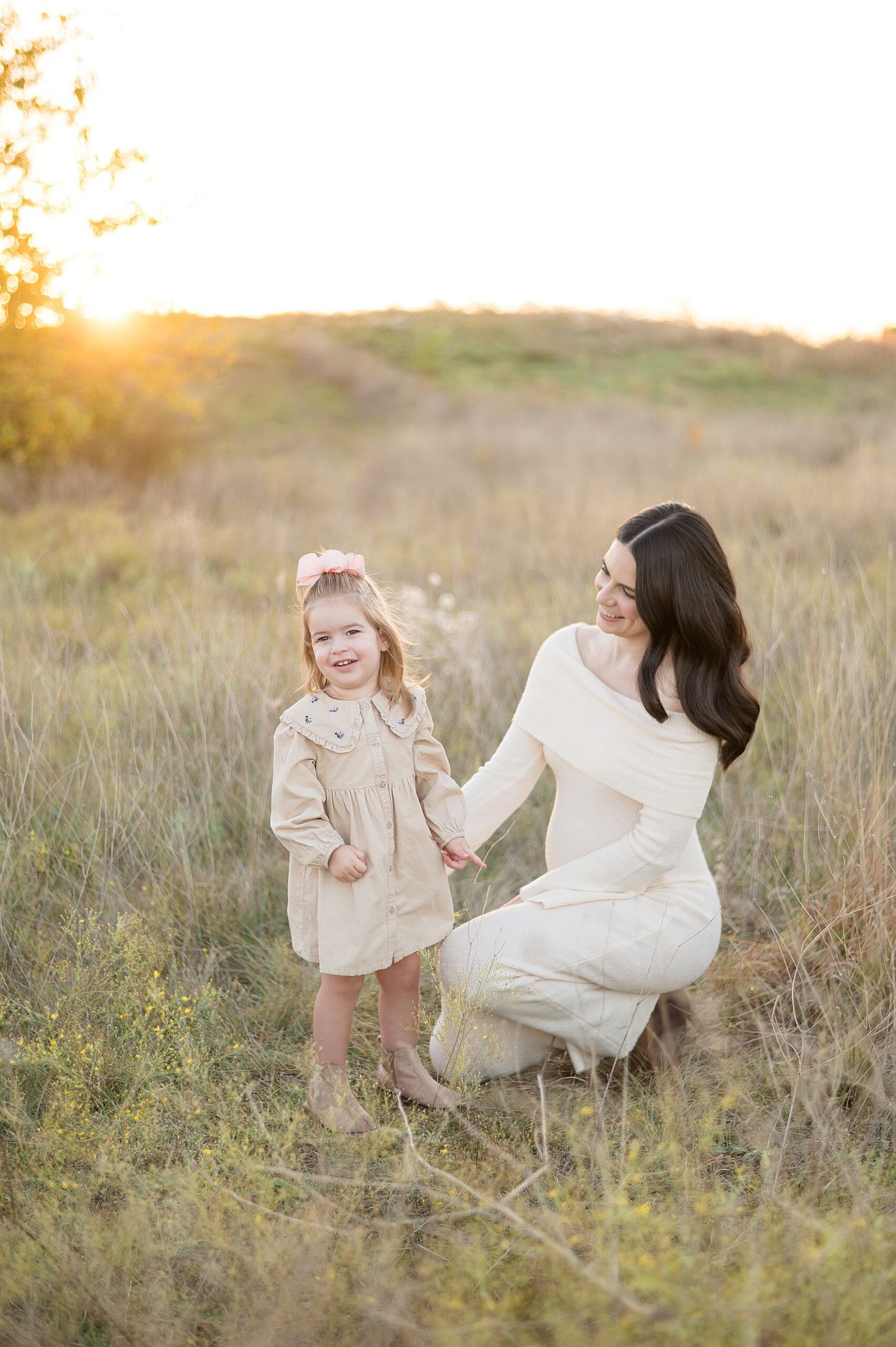 mom with little girl in field at Arbor Hills in Plano Tx