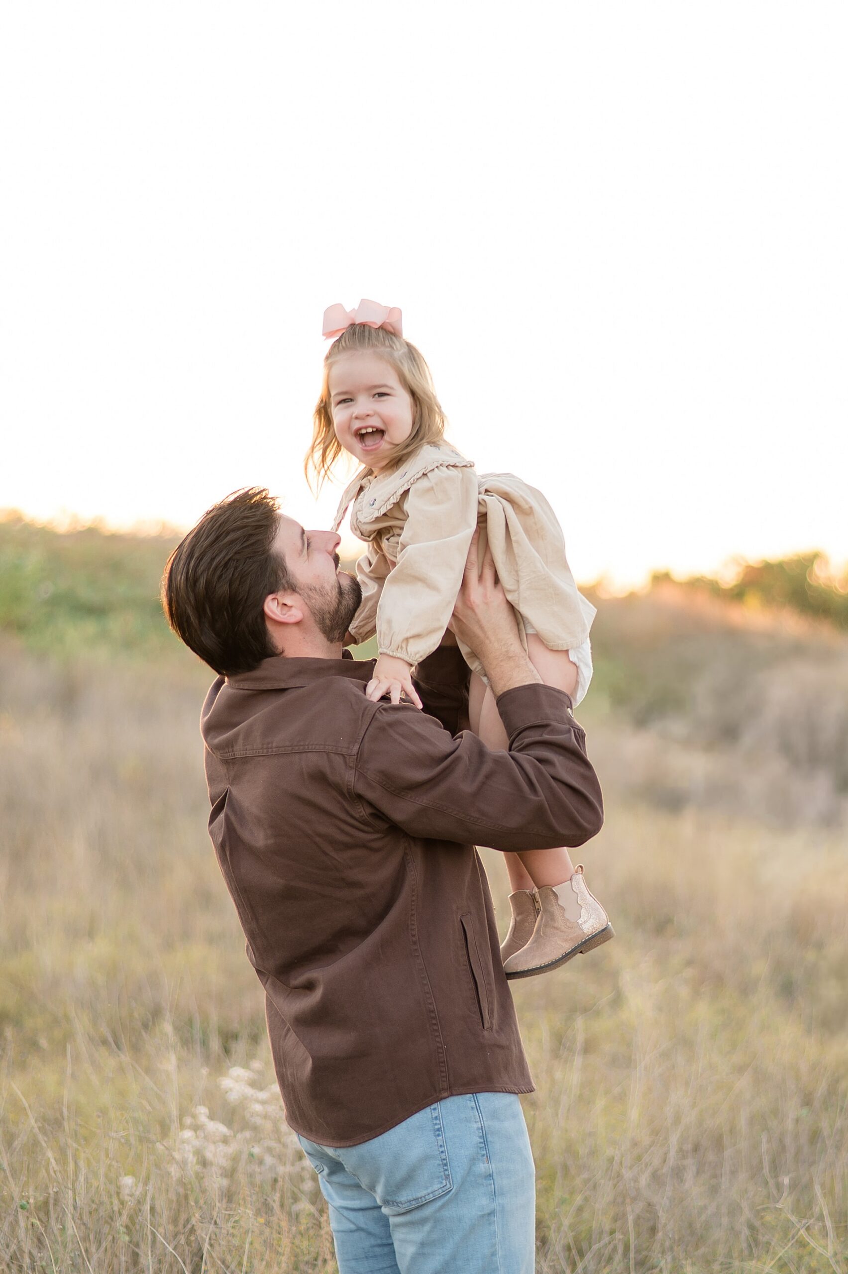 Dad holds little girl photographed by   Arbor Hills Maternity announcement photographer  