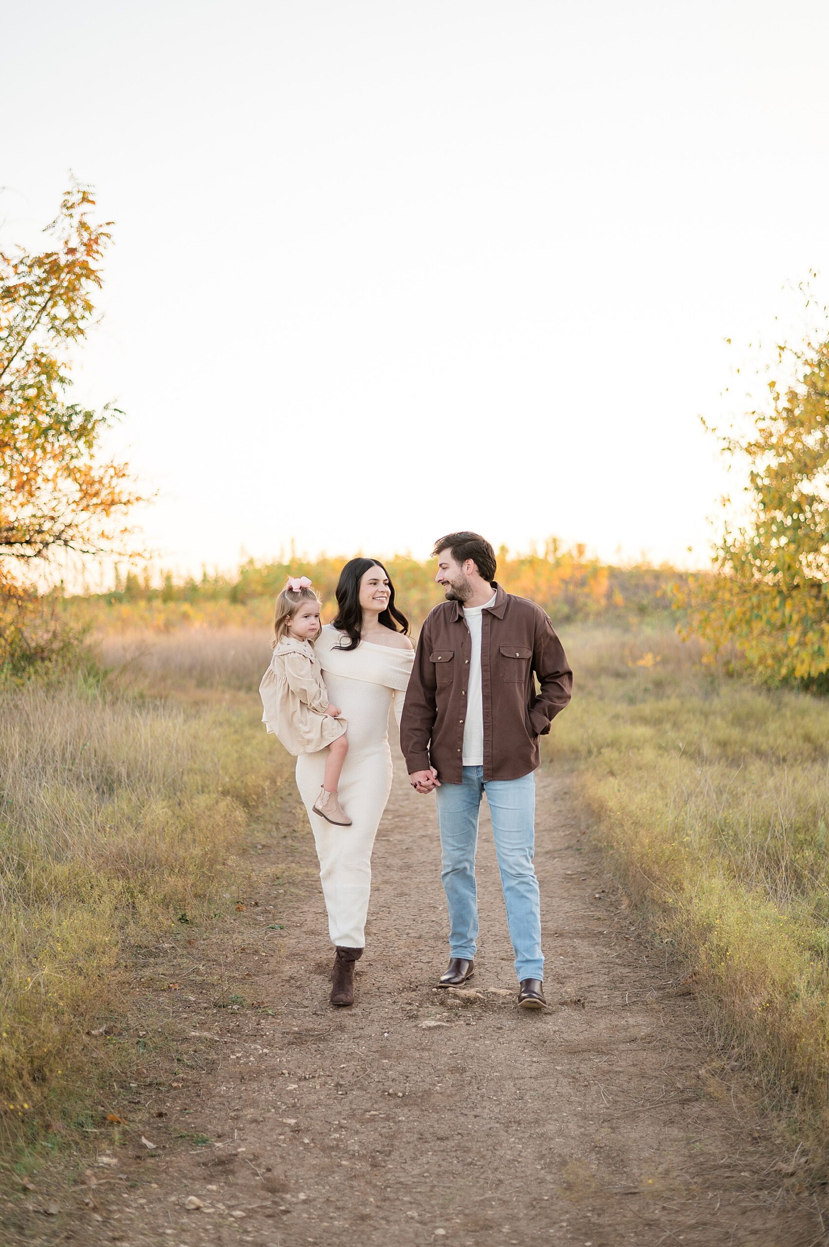 family walks together during maternity announcement in Plano, TX 