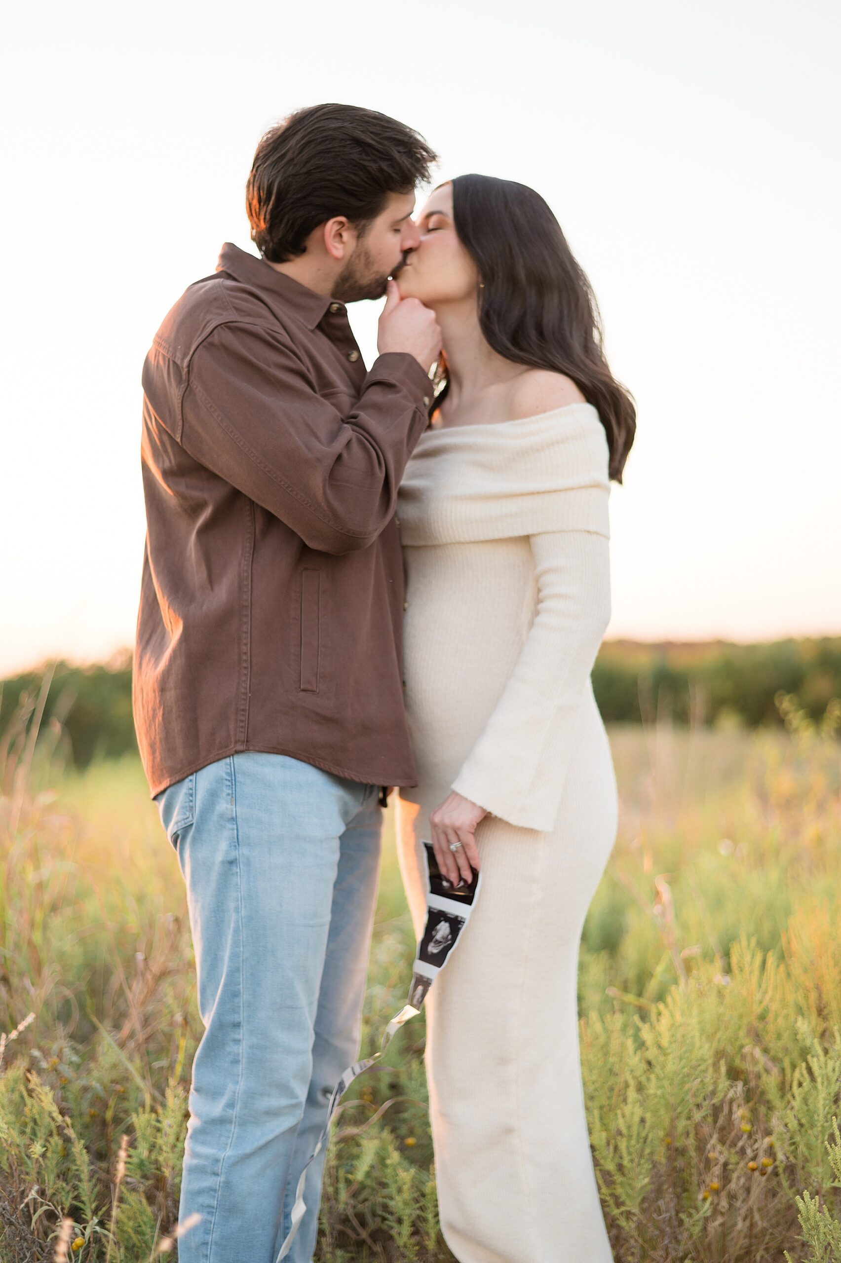 couple kiss during Arbor Hills Maternity announcement 