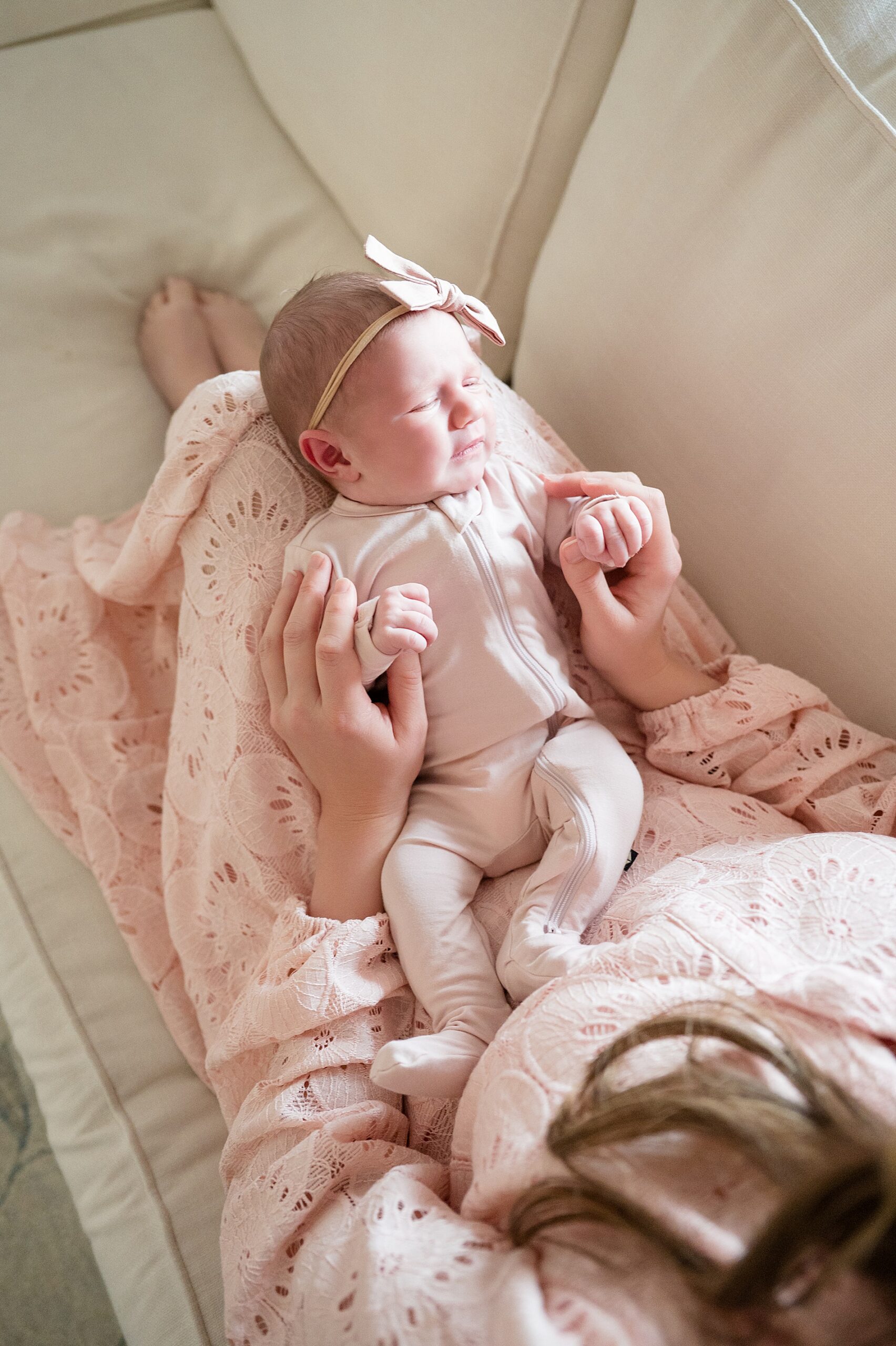 sleepy newborn girl in lap